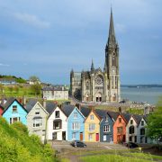 Colorful Row Of Houses With A Cathedral In The Background In Cobh Near Cork, Ireland